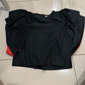 Cute Never worn black ruffle sleeve top with pink and orange undertone.